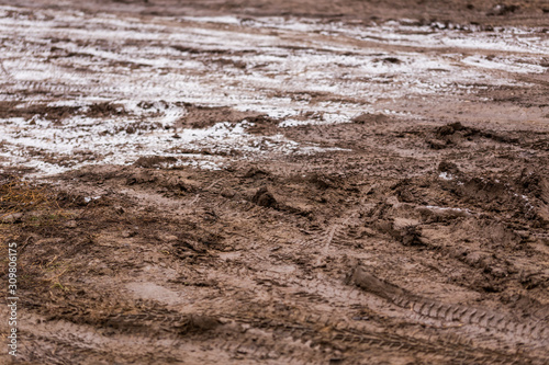 dirty mud road background at winter with selective focus and blur