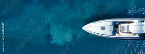 Aerial drone ultra wide top down photo of luxury rigid inflatable speed boat cruising in high speed in Aegean deep blue sea, Greece