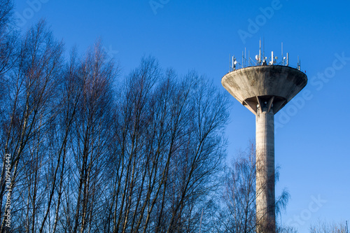 Water tower and many communication antennas mounted on top.