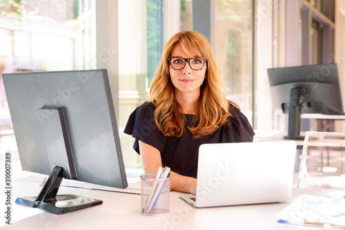 Executive businesswoman working on laptop in the office