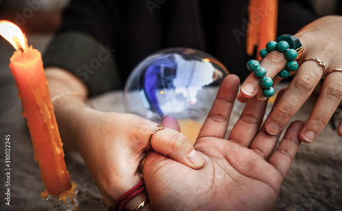 Fortune telling casts a spell, witchcraft with Magic crystal ball in Ceremony . Concept of Astrology, Horoscope and alchemy , Maya magic , superstition , predictions and mysterious mystical .