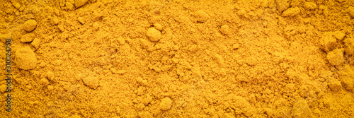 Turmeric root powder background and texture