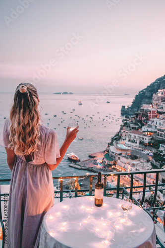 Young woman with blonde hair on balcony in Positano italy