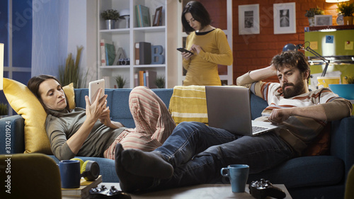 Friends connecting with their devices at home and ignoring each other