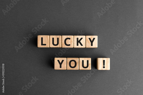 lucky you - phrase words from wooden blocks with letters, lucky you concept, top view gray background