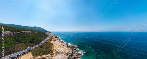 Beautiful wide panorama, aerial view of the public beach, a place to relax, people sunbathe, boats go on the water, copy space. Mediterranena coast in Livorno, Tuscany, Italy