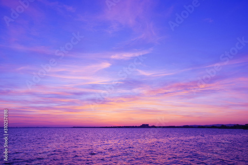 Colorful sunset over the sea. Purple sky.