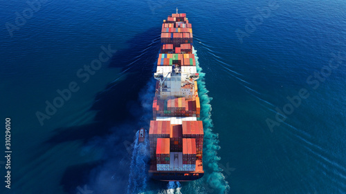 Aerial drone photo of industrial cargo container tanker ship carrier cruising the open ocean deep blue sea