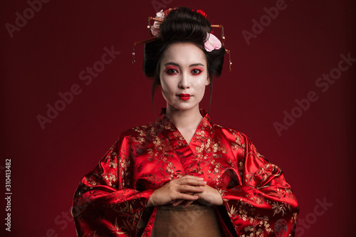 Image of beautiful young geisha woman in traditional japanese kimono