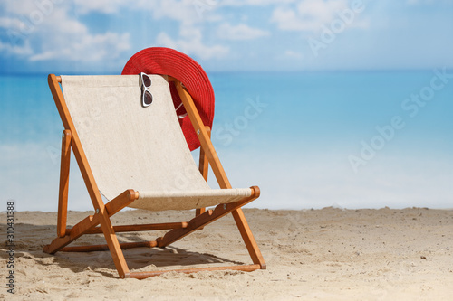 Beach deck chair on a sandy beach by the sea. Summer mood. Space to copy