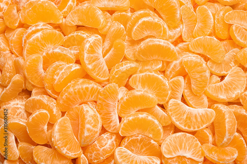 Fresh juicy tangerine segments as background, top view