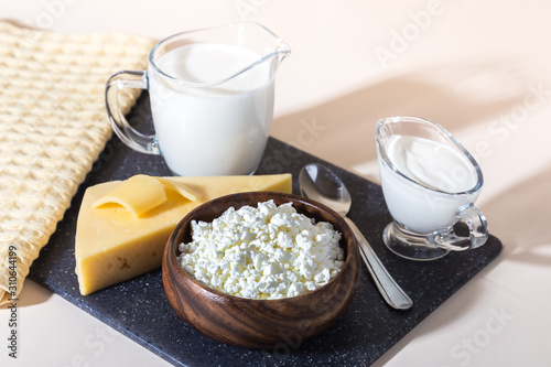 Food, source of calcium, magnesium, protein, fats, carbohydrates, balanced diet. Dairy products on the table: cottage cheese, sour cream, milk, cheese, contain casein, albumin, globulin, free lactose