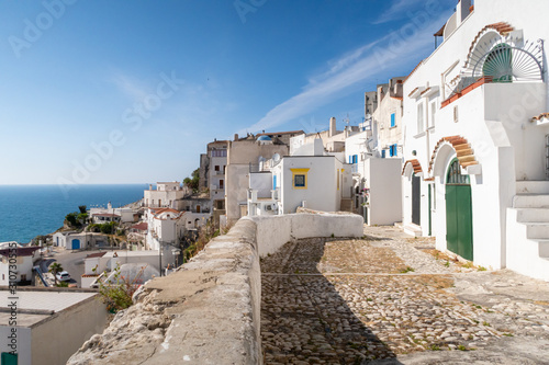 The historic center of Peschici with its typical white houses overlooking the sea, Gargano, Puglia.