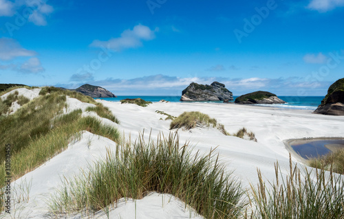 The powder white snad beaches of wharariki near nelson on new zealands south island.