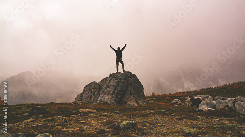 Dramatic Silhouette Of Victorious Man Celebrating With Arms In Air