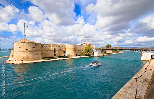 Aragonese Castle of Taranto and revolving bridge on the channel between Big and Small sea, Puglia, Italy, Blue sunny sky 