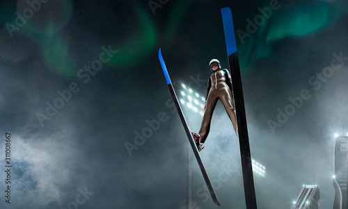 Skier in flight. Ski jumping in evening.