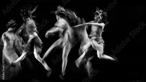  scenography of dancers dancing in black and white, blurred effect photography