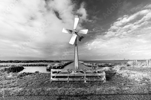 Black and white shot of Windmill in Dutch landscpae