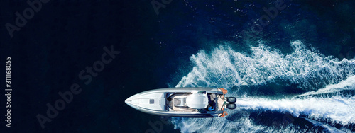 Aerial drone ultra wide panoramic photo of high speed inflatable rib boat cruising in high speed in tropical exotic bay