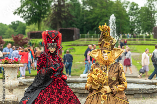 ANNEVOIE GARDENS, BELGIUM - June 9, 2019: Women standing in masks and masquerade costumes during Venetian carnival in Annevoie gardens, Rue des jardins, 37 a, Annevoie/ Belgium