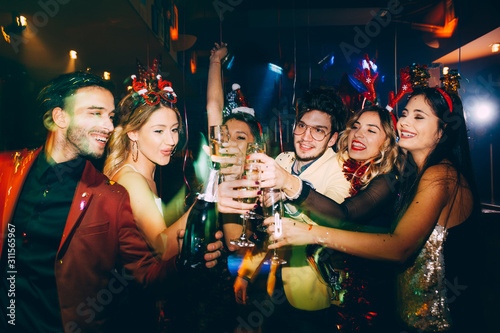 Group of friends having fun and toasting at New Year's party