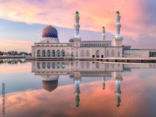 Bandaraya Mosque at Sunset in Kota Kinabalu, Sabah, Malaysia. Beautiful colors and amazing reflections in popular tourist destination on Borneo island.