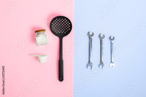 Gender stereotypes: division of men and women specific tasks or activities. Kitchenware opposed to mechanic repair tools in studio background