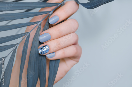 Beautiful female hand with blue nail design