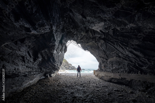 Landscape of cave in Vernazza, Traveler man looking somewhere on sand beach in Cinque Terre, Travel popular place Italy