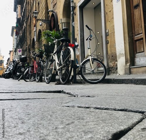 Low angle of bicycles parked on the narrow streets of Rome