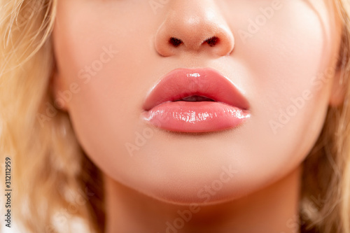 Lips. Beauty injections concept. Close up view of beautiful woman lips with Peachy lipstick. Fashion make up. Cosmetology, drugstore or fashion makeup. Studio shot. Perfect sexy Lips. 