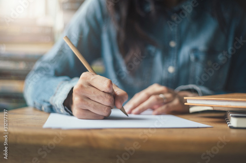 high school,university student study.hands holding pencil writing paper answer sheet.sitting lecture chair taking final exam attending in examination classroom.concept scholarship for education abroad