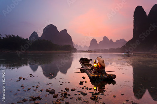 Cormorant fisherman on the Li River, near the town of Xingping in Guangxi province, China. This area is renowned for its Karst topography.