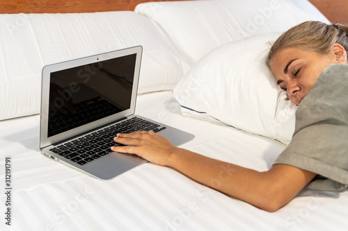 girl tired of using her laptop in bed has fallen asleep