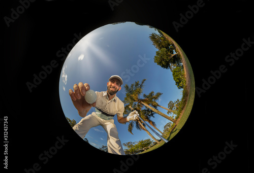 Golfer picks up golf ball out of golf hole, after hole in one