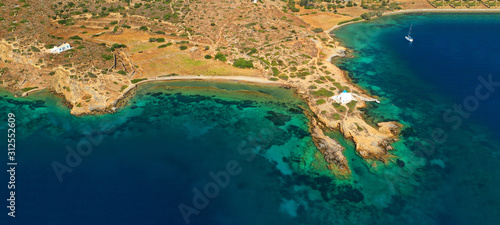 Aerial drone ultra wide photo of iconic small chapel of Agios Panteleimon next to emerald beach of Maltezi, Amorgos island, Cyclades, Greece