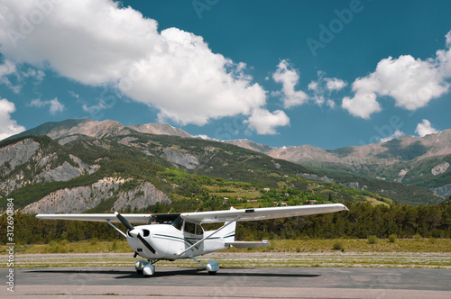 Single engine piston Cessna 172 parked at an airfield in the mountains