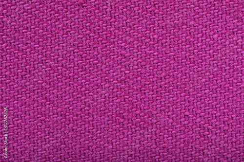 twill weaving fabric, pink stitches as pattern, tissue structure closeup.