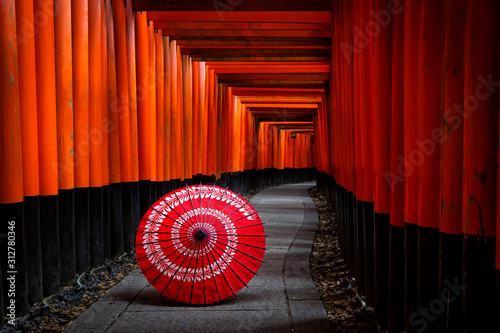 Kyoto,Japan - November 22,2019 : Japanese Umbrella and red torii gates walkway at fushimi inari shrine in Kyoto,Japan.
