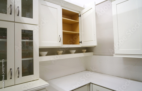 close up on white kitchen cabinet with door open