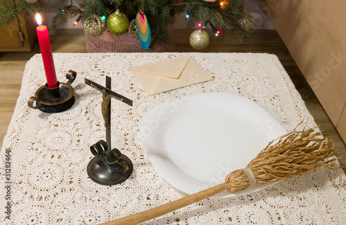 Pastoral visit articles on a table: cross, holy water, sprinkler and envelope with donation. Tradition of catholic church in Poland called koleda