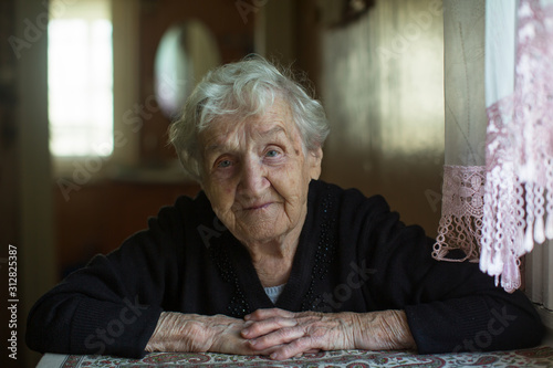 Home portrait of an elderly gray-haired granny woman.