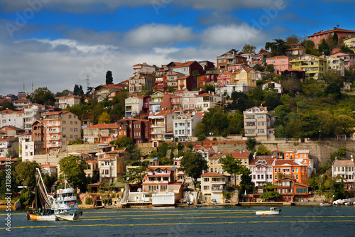 Purse Seine fishing boat on the Bosphorus Strait with houses on hill at Yeni Mahalle Sariyer Turkey