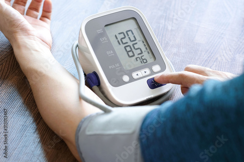 Man check blood pressure monitor and heart rate monitor with digital pressure gauge. Health care and Medical concept