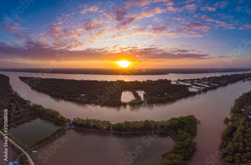 Aerial view Mekong River Delta region, Ben Tre, South Vietnam. Water canals and tropical fluvial islands dramatic sky at sunset.