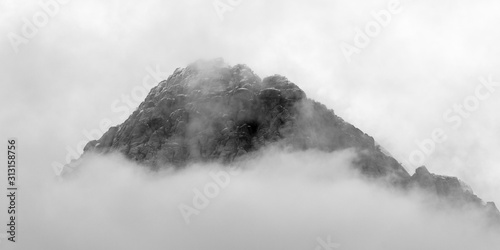 Panoramic black and white view of cloud covered desert mountain peak at Red Rock Canyon National Conservation Area. A popular natural area 20 miles from the Las Vegas strip in Southern Nevada. 