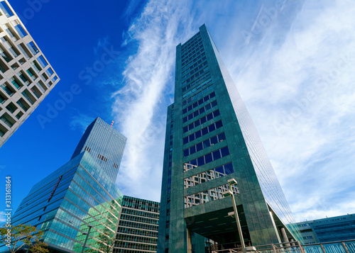 Glass Business office buildings architecture in Modern City in Vienna in Austria. Urban corporate skyscraper exterior and skyline. Blue windows design of Finance commercial center. Background view.