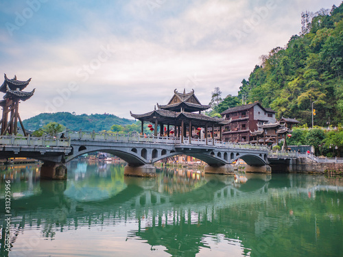 fenghuang,Hunan/China-16 October 2018:Tourist on Fenghuang old town bridge with Scenery view of fenghuang old town .phoenix ancient town or Fenghuang County is a county of Hunan Province, China
