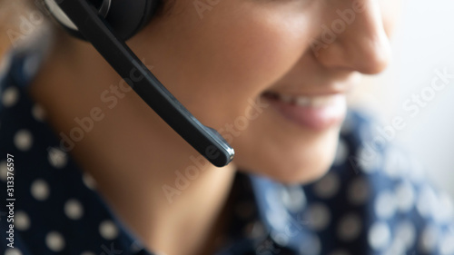 Telesales call center agent wear headset consult customer, closeup view